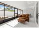 Bright sunroom featuring tile floors, large windows, and comfortable seating area at 11811 Cypress Crest Cir, Tampa, FL 33626