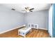 Bright living room with hardwood floors, a ceiling fan, and a white cabinet at 12250 Mallory Dr, Largo, FL 33774