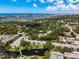 Aerial view of waterfront condos, showcasing landscaping, lake, and surrounding coastal community at 14130 Rosemary Ln # 3215, Largo, FL 33774
