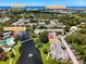 Aerial view of a condo complex, with a lake, landscaping, and Gulf of Mexico in the background at 14130 Rosemary Ln # 3215, Largo, FL 33774