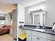 Modern vanity in bathroom with a view of the bedroom next door at 14130 Rosemary Ln # 3215, Largo, FL 33774