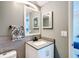Updated bathroom with modern vanity, stylish mirror, and decorative towel near the toilet at 14130 Rosemary Ln # 3215, Largo, FL 33774