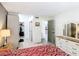 Bedroom features a large dresser, closet, and adjacent bathroom and kitchen at 14130 Rosemary Ln # 3215, Largo, FL 33774