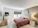 Cozy bedroom with a comfortable bed, dresser, and window for natural light at 14130 Rosemary Ln # 3215, Largo, FL 33774