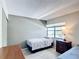 Comfortable bedroom with a twin bed, dresser, and a large window for natural light at 14130 Rosemary Ln # 3215, Largo, FL 33774