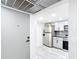 A view of the kitchen with modern stainless steel appliances and grey tile backsplash and light grey cabinets at 14130 Rosemary Ln # 3215, Largo, FL 33774