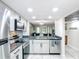 A view from the kitchen into the living room with granite countertops and stainless steel appliances at 14130 Rosemary Ln # 3215, Largo, FL 33774