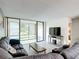 Relaxing living room with comfortable seating, coffee table, and sliding glass doors to the outdoors at 14130 Rosemary Ln # 3215, Largo, FL 33774