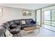 Comfortable living room with a sectional sofa, sliding glass doors, and a stylish coffee table at 14130 Rosemary Ln # 3215, Largo, FL 33774
