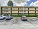 Image shows parking for the units with landscaping at 14130 Rosemary Ln # 3215, Largo, FL 33774
