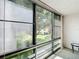 Bright sunroom with textured walls, large window view of lush green landscaping at 14130 Rosemary Ln # 3215, Largo, FL 33774