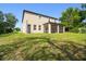 Rear view of the house showing the back yard and screened in patio at 14282 Coronado Dr, Spring Hill, FL 34609