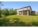 Spacious backyard features a well-maintained lawn and a screened porch on the rear of the house at 14282 Coronado Dr, Spring Hill, FL 34609