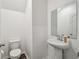 Powder room with pedestal sink and toilet featuring modern fixtures and finishes at 14282 Coronado Dr, Spring Hill, FL 34609
