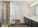 Bright bathroom with a glass-enclosed shower and soaking tub, complemented by a modern vanity and wood-look flooring at 14282 Coronado Dr, Spring Hill, FL 34609