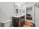 Bathroom with double vanity sink and hardwood style flooring, that connects to a bedroom with twin sized bunk beds at 14282 Coronado Dr, Spring Hill, FL 34609