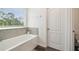 Bathroom with large tub under a window with tile backsplash at 14282 Coronado Dr, Spring Hill, FL 34609