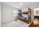 Cozy bedroom showcasing a wood bunk bed with ladder and ensuite bathroom at 14282 Coronado Dr, Spring Hill, FL 34609