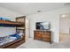 Bedroom featuring bunk beds, a dresser with a TV, and neutral carpeting, creating a functional and comfortable space at 14282 Coronado Dr, Spring Hill, FL 34609