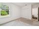 Carpeted bedroom featuring a window, closet, and an ensuite bathroom at 14282 Coronado Dr, Spring Hill, FL 34609