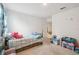 bedroom featuring carpeted floors, a single bed, and colorful toy storage, bathed in natural light at 14282 Coronado Dr, Spring Hill, FL 34609