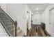 Hallway with staircase and access to half-bathroom with wood-look flooring at 14282 Coronado Dr, Spring Hill, FL 34609