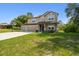 Attractive two-story home featuring a three-car garage, basketball hoop, and a well-maintained lawn at 14282 Coronado Dr, Spring Hill, FL 34609