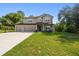 Charming two-story home with a three-car garage and a well-manicured lawn, complete with a basketball hoop at 14282 Coronado Dr, Spring Hill, FL 34609
