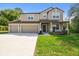 Inviting two-story home with three-car garage, covered porch, and well-maintained lawn in a Gathering-friendly neighborhood at 14282 Coronado Dr, Spring Hill, FL 34609
