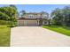 Lovely two-story home boasting a spacious driveway with a basketball hoop and a well-kept lawn, perfect for families at 14282 Coronado Dr, Spring Hill, FL 34609
