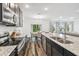 Kitchen with an island, stainless steel appliances, granite countertops, and dark cabinets at 14282 Coronado Dr, Spring Hill, FL 34609