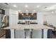 Kitchen with stainless steel appliances, granite countertops, a large island, and dark wood cabinets at 14282 Coronado Dr, Spring Hill, FL 34609