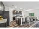 Kitchen features a large granite island, stainless steel appliances, dark cabinets, and wood floors at 14282 Coronado Dr, Spring Hill, FL 34609