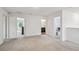 Spacious carpeted living area providing access to bedrooms and a bathroom at 14282 Coronado Dr, Spring Hill, FL 34609