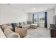 Well-lit living room featuring a comfortable L-shaped couch at 14282 Coronado Dr, Spring Hill, FL 34609