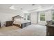 Spacious main bedroom with carpeted flooring and large windows with great views at 14282 Coronado Dr, Spring Hill, FL 34609
