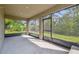 Relaxing screened porch overlooking a green yard, perfect for enjoying the outdoors in comfort at 14282 Coronado Dr, Spring Hill, FL 34609