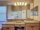 Bathroom featuring double sinks, wood cabinets, granite counters, decorative lighting and walk in shower at 16219 Nottingham Park Way, Tampa, FL 33647