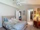 Inviting bedroom features plush carpeting, a comfortable bed, and access to ensuite bathroom at 16219 Nottingham Park Way, Tampa, FL 33647