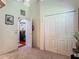 Spare bedroom featuring carpet, ceiling fan, double door closet and view through doorway to the kitchen at 16219 Nottingham Park Way, Tampa, FL 33647