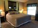 Bedroom features a four-poster bed with neutral bedding and a large wall mirror above the headboard at 16219 Nottingham Park Way, Tampa, FL 33647