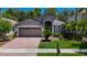 Charming single-Gathering home with a well-maintained front yard, beautiful landscaping, and a two-car garage at 16219 Nottingham Park Way, Tampa, FL 33647
