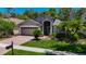 Charming single-story home with well-manicured lawn, mature trees, and attached two-car garage at 16219 Nottingham Park Way, Tampa, FL 33647