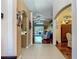Inviting foyer featuring tile flooring and arched entryways leading to the living room and kitchen area at 16219 Nottingham Park Way, Tampa, FL 33647