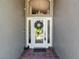 Elegant front door featuring glass panels and decorative wreath creates a welcoming entrance at 16219 Nottingham Park Way, Tampa, FL 33647