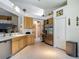 Spacious kitchen with stainless steel appliances, light wood cabinets, and tile flooring at 16219 Nottingham Park Way, Tampa, FL 33647