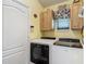 Functional laundry room with modern washer, dryer, and convenient overhead cabinet storage at 16219 Nottingham Park Way, Tampa, FL 33647