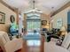 Bright living room features wood floors, high ceilings, comfortable seating, and a large window overlooking the backyard at 16219 Nottingham Park Way, Tampa, FL 33647