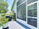 Relaxing screened-in patio with seating, grill and view of lush landscaping, perfect for entertaining at 16219 Nottingham Park Way, Tampa, FL 33647