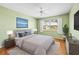 Cozy bedroom with hardwood floors, ceiling fan, large windows, and stylish decor at 1908 Canterbury Ln # 28, Sun City Center, FL 33573